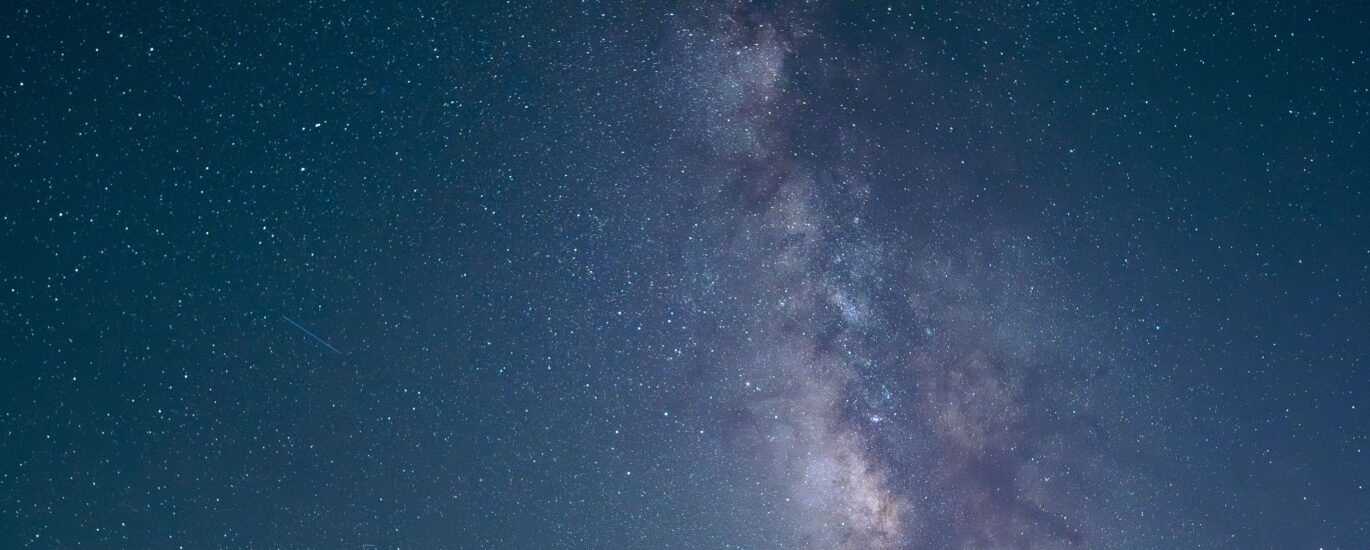 Stunning nightscape featuring the Milky Way galaxy visible over a tranquil desert road.